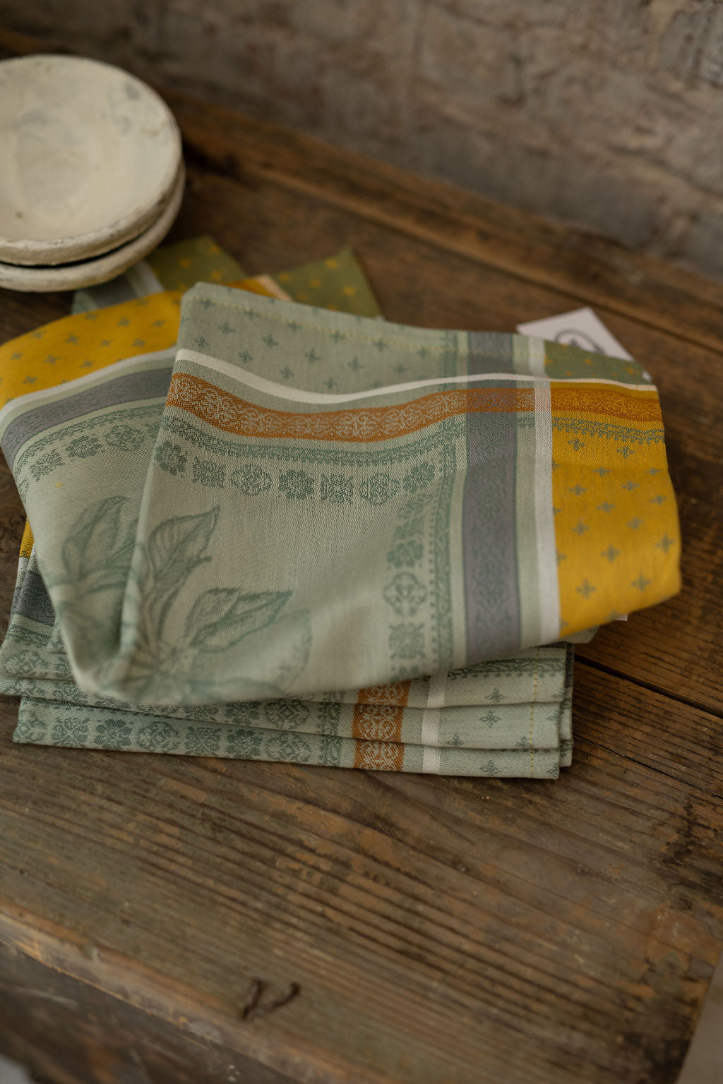 Stack of patterned napkins on a wooden surface