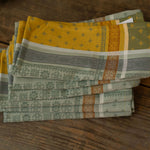 Stack of patterned napkins on a wooden surface