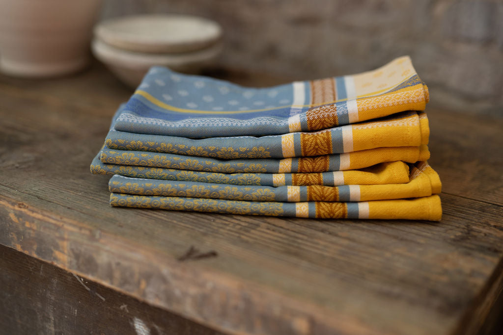 Stack of folded patterned napkins on a wooden surface