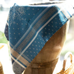 Blue patterned fabric draped over a wooden stool