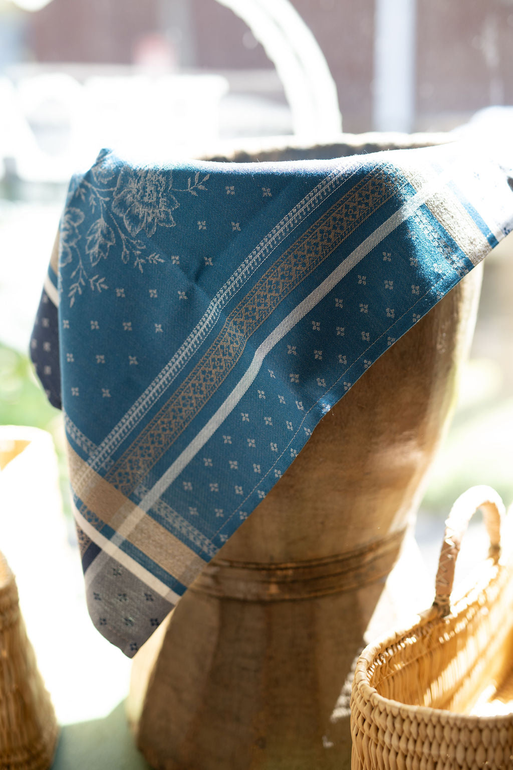 Blue patterned fabric draped over a wooden stool