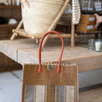 Handbag with striped pattern on a wooden surface