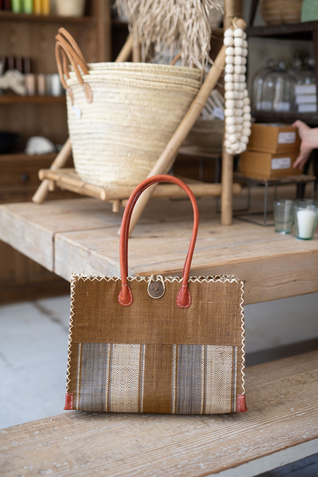 Handbag with striped pattern on a wooden surface