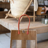 Handbag with striped pattern on a wooden surface